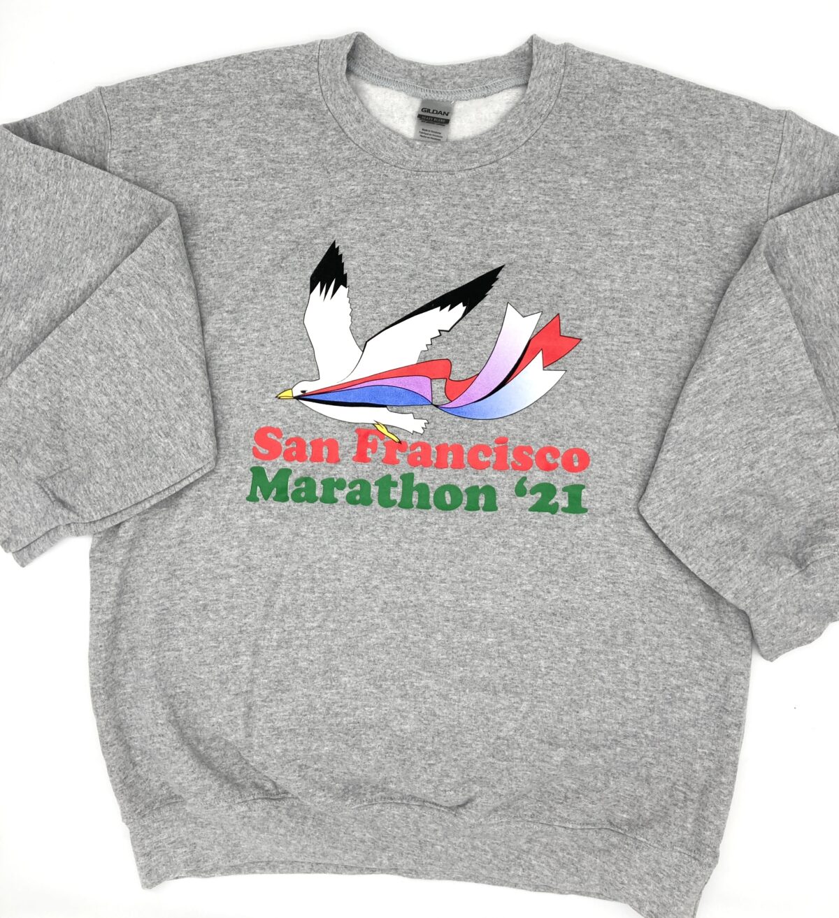 Front detail of the San Francisco Marathon 80's vintage inspired crewneck sweatshirt depicting a seagull flying with a band of colored ribbons in its beak.