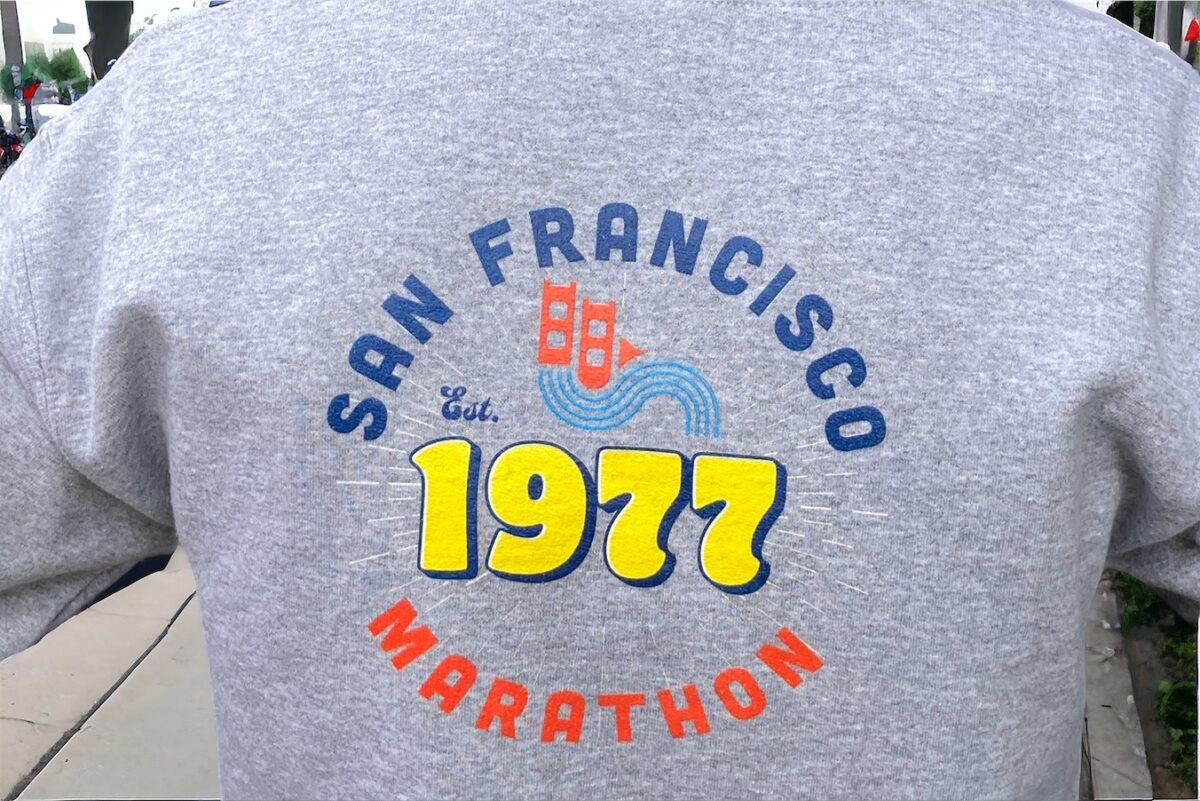 Close up of the back of grey hooded sweatshirt showing San Francisco Marathon established 1977 design screenprinted.